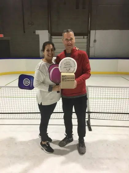 The week one champions holding the trophy and paddles