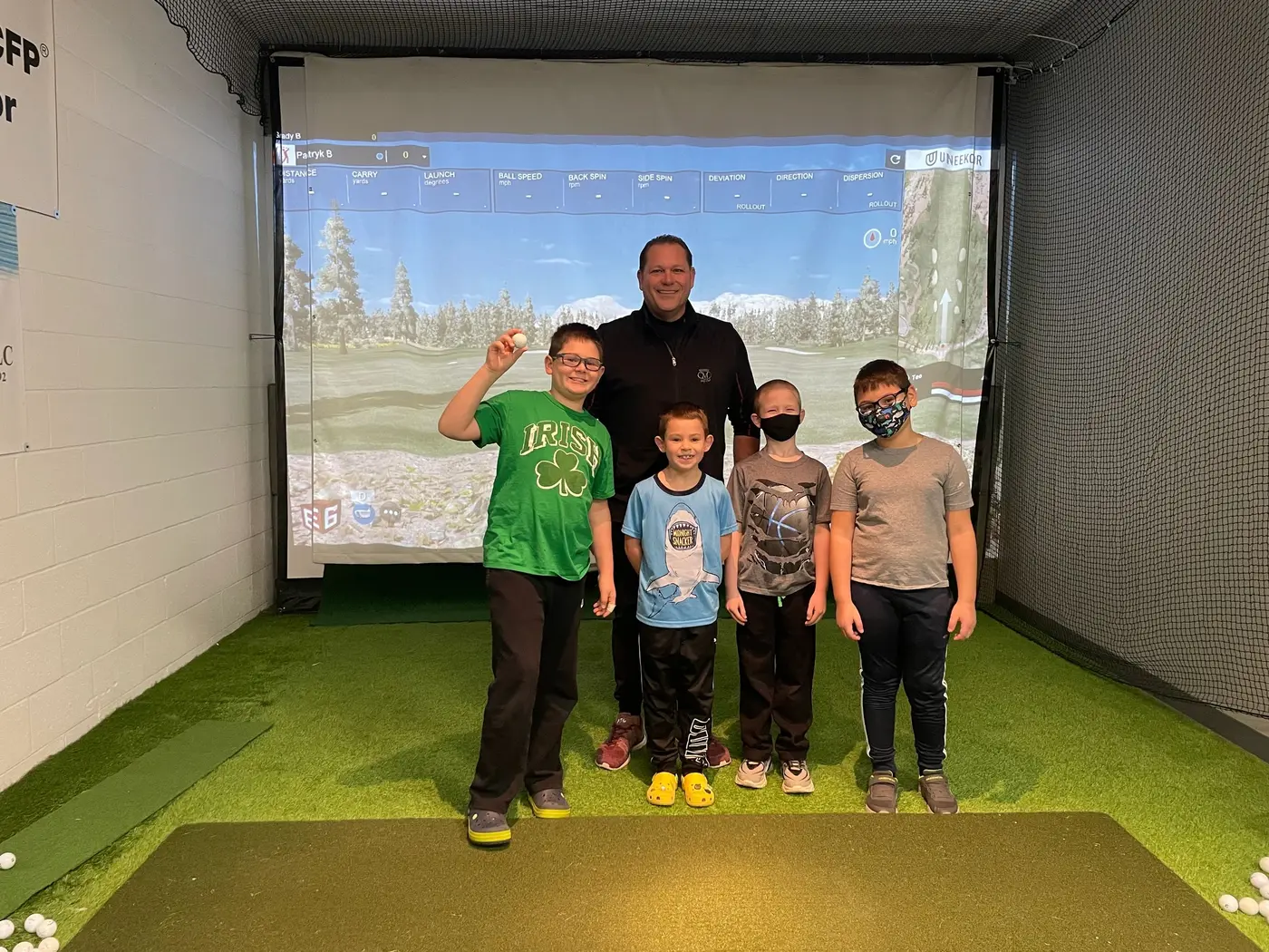 A coach with five young students in the simulator bay